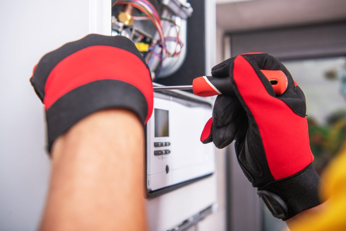 Riley, Inc. technician servicing a gas-fired heating unit in Altoona, PA